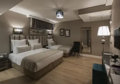 a hotel room with a large bed and a chair at Le Petit Palace Hotel - Special Category in Istanbul