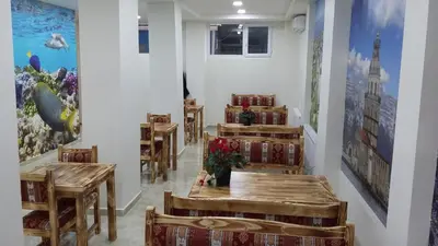 a restaurant with tables and chairs and paintings on the wall at Seyri Istanbul Hotel in Istanbul