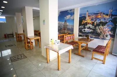 a room with tables and chairs and a large mural at Seyri Istanbul Hotel in Istanbul