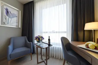 a room with a table and chairs and a window at Holiday Inn Bursa - City Centre by IHG in Bursa