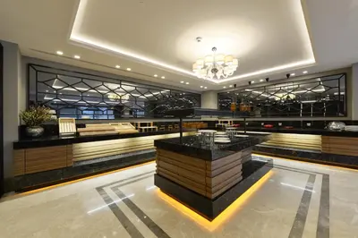 a restaurant with a bar in the middle of a room at Holiday Inn Bursa - City Centre by IHG in Bursa