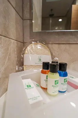 three bottles of paint sitting on a bathroom sink at Holiday Inn Bursa - City Centre by IHG in Bursa