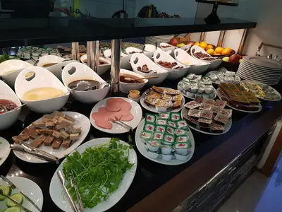 a buffet with many plates of food on a table at Business Palas Otel in Kocaeli