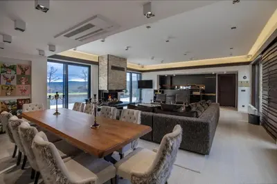 a dining room and living room with a table and chairs at Palivor Çiftliği in Korfo
