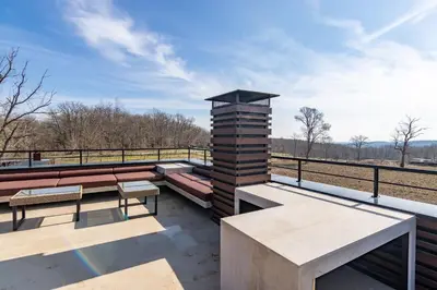 a patio with benches and tables on a roof at Palivor Çiftliği in Korfo