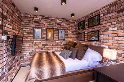 a bedroom with a brick wall with a bed in it at Palivor Çiftliği in Korfo