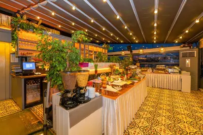 a restaurant with a bar with plants on it at Alpek Hotel in Istanbul