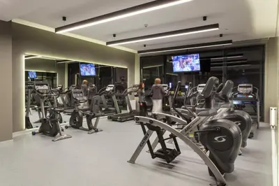 a gym with treadmills and cardio equipment in a building at Fraser Place Antasya Istanbul in Istanbul