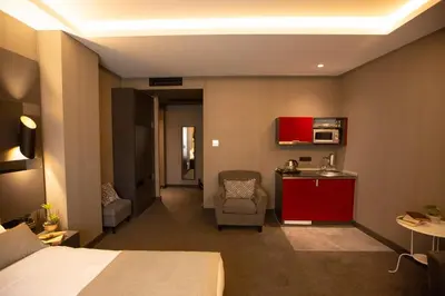 a hotel room with a bed and a kitchen at Cityloft 24 in Istanbul