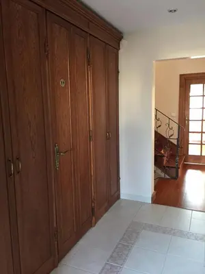 a living room with wooden cabinets and a staircase at Villa Bursa in Bursa