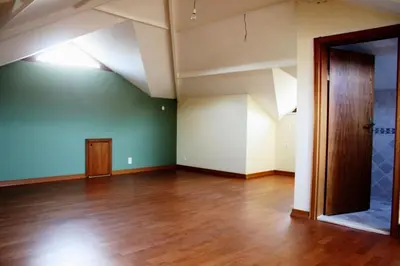 an empty room with a wooden floor and an open door at Villa Bursa in Bursa