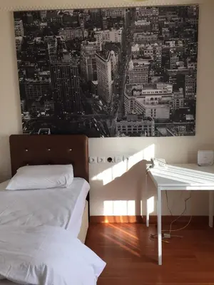 a room with two beds and a desk with a picture on the wall at Villa Bursa in Bursa