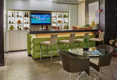 a restaurant with a green bar with chairs and tables at Richmond Nua Wellness Spa - Adult Only in Sapanca