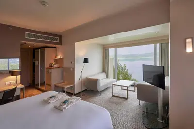 a hotel room with a bed and a large window at Richmond Nua Wellness Spa - Adult Only in Sapanca