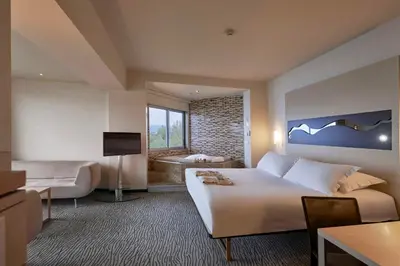 a hotel room with a large bed and a television at Richmond Nua Wellness Spa - Adult Only in Sapanca