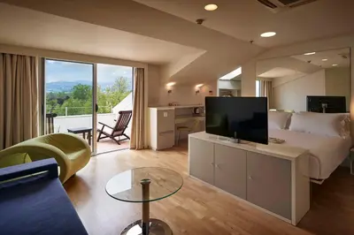 a hotel room with a bed and a living room at Richmond Nua Wellness Spa - Adult Only in Sapanca