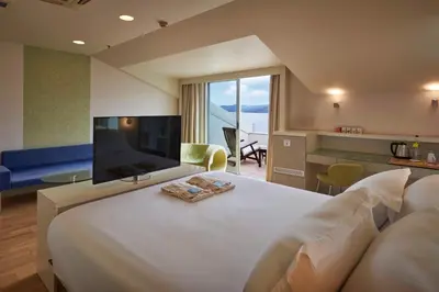 a hotel room with a large bed and a television at Richmond Nua Wellness Spa - Adult Only in Sapanca