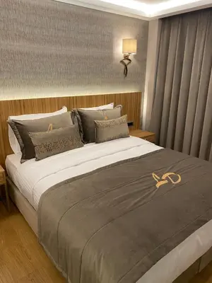 a bedroom with a large bed with a pair of gold shoes on it at Lady Diana Hotel in Istanbul