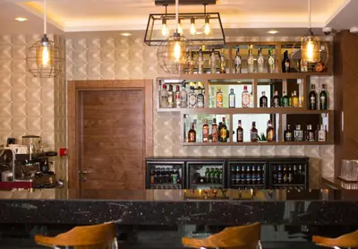 a bar with a lot of bottles of alcohol at Görükle Güler Park Hotel in Gorukle