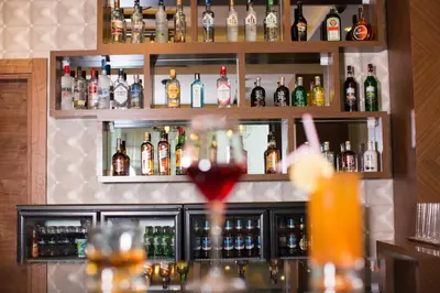 a bar with a lot of bottles of alcohol at Görükle Güler Park Hotel in Gorukle