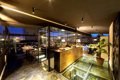 a restaurant with a glass counter and a table at Walton Hotels Galata in Istanbul