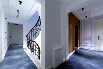 a hallway of a home with a staircase with white walls at Walton Hotels Galata in Istanbul