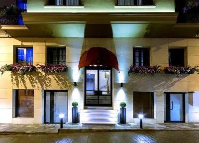 a building with stairs and flowers in front of it at Walton Hotels Galata in Istanbul