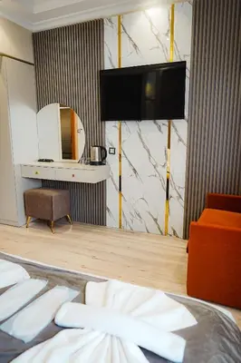 a hotel room with a bed and a tv on the wall at Reyyan Hotel in Istanbul