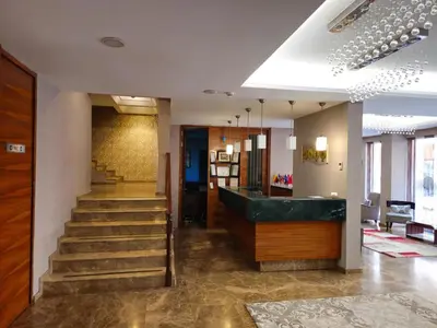 a lobby with a staircase with a green counter at Pasa Hotel Gemlik in Gemlik