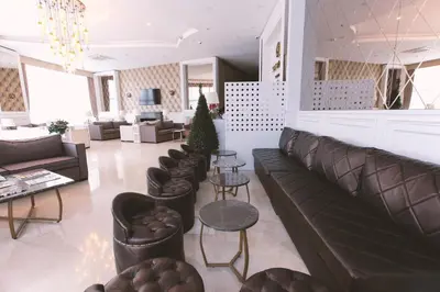 a living room with leather furniture and a christmas tree at Serenity Suites Istanbul Airport in Istanbul