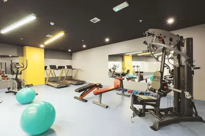a gym with several tread machines and exercise equipment at Serenity Suites Istanbul Airport in Istanbul