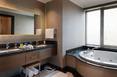 a bathroom with a tub and a sink and a mirror at Istanbul Marriott Hotel Asia in Istanbul