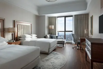 a hotel room with two beds and a desk at Istanbul Marriott Hotel Asia in Istanbul