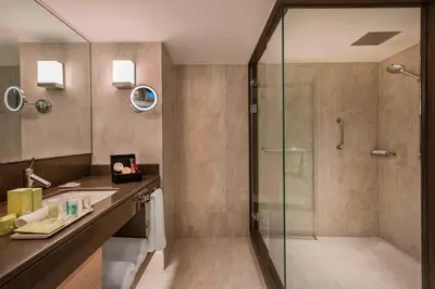 a bathroom with a glass shower and a sink at Renaissance Polat Istanbul Hotel in Istanbul
