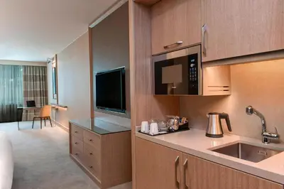 a room with a kitchen with a sink and a microwave at Renaissance Polat Istanbul Hotel in Istanbul