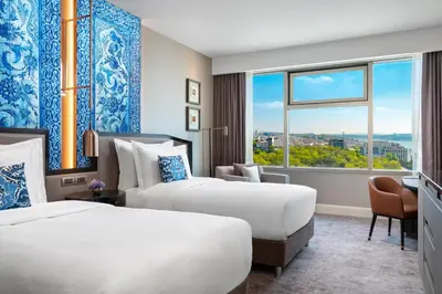 a hotel room with two beds and a window at The Ritz-Carlton, Istanbul at the Bosphorus in Istanbul