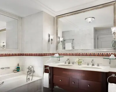 a bathroom with two sinks and a tub and a mirror at The Ritz-Carlton, Istanbul at the Bosphorus in Istanbul