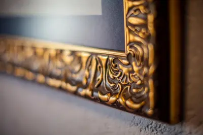 a mirror with a gold frame on a wall at Vavien Hotel in Istanbul