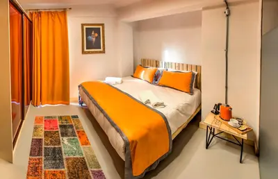 a bedroom with a large bed with orange pillows at Vavien Hotel in Istanbul