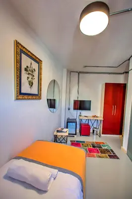a bedroom with an orange bed and a desk at Vavien Hotel in Istanbul