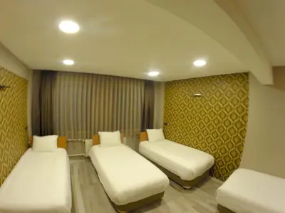 a room with two beds and two chairs at Okur Otel in Istanbul