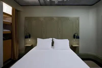 a bedroom with a large bed with two white pillows at The Cettia Istanbul in Istanbul