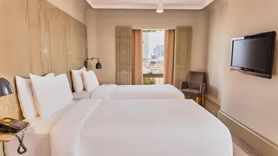 a hotel room with two beds and a television at The Cettia Istanbul in Istanbul