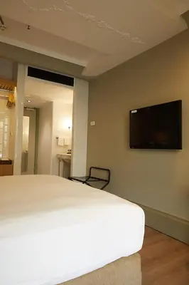a bedroom with a bed and a flat screen tv on the wall at The Cettia Istanbul in Istanbul