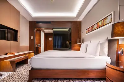a bedroom with a large white bed in a room at Grand Harilton Otel in Istanbul