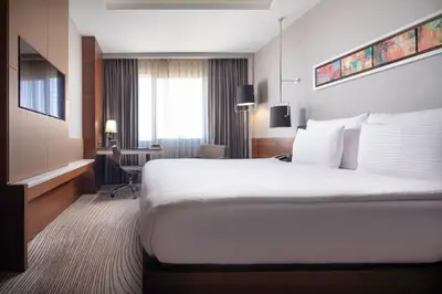 a hotel room with a large bed and a desk at Grand Harilton Otel in Istanbul