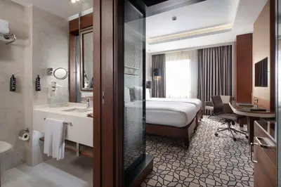 a hotel room with a bed and a bathroom at Grand Harilton Otel in Istanbul