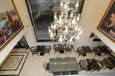 a room with a chandelier and a table and chairs at Art Nouveau Pera in Istanbul