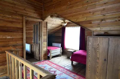 a log cabin with a staircase and a bedroom at Uludag Orman Koskleri in Uludag