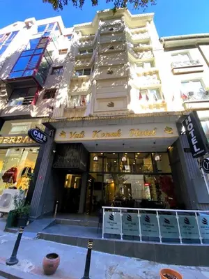 a store front of a tall building with a store at Vali Konak Hotel Nişantaşı in Istanbul